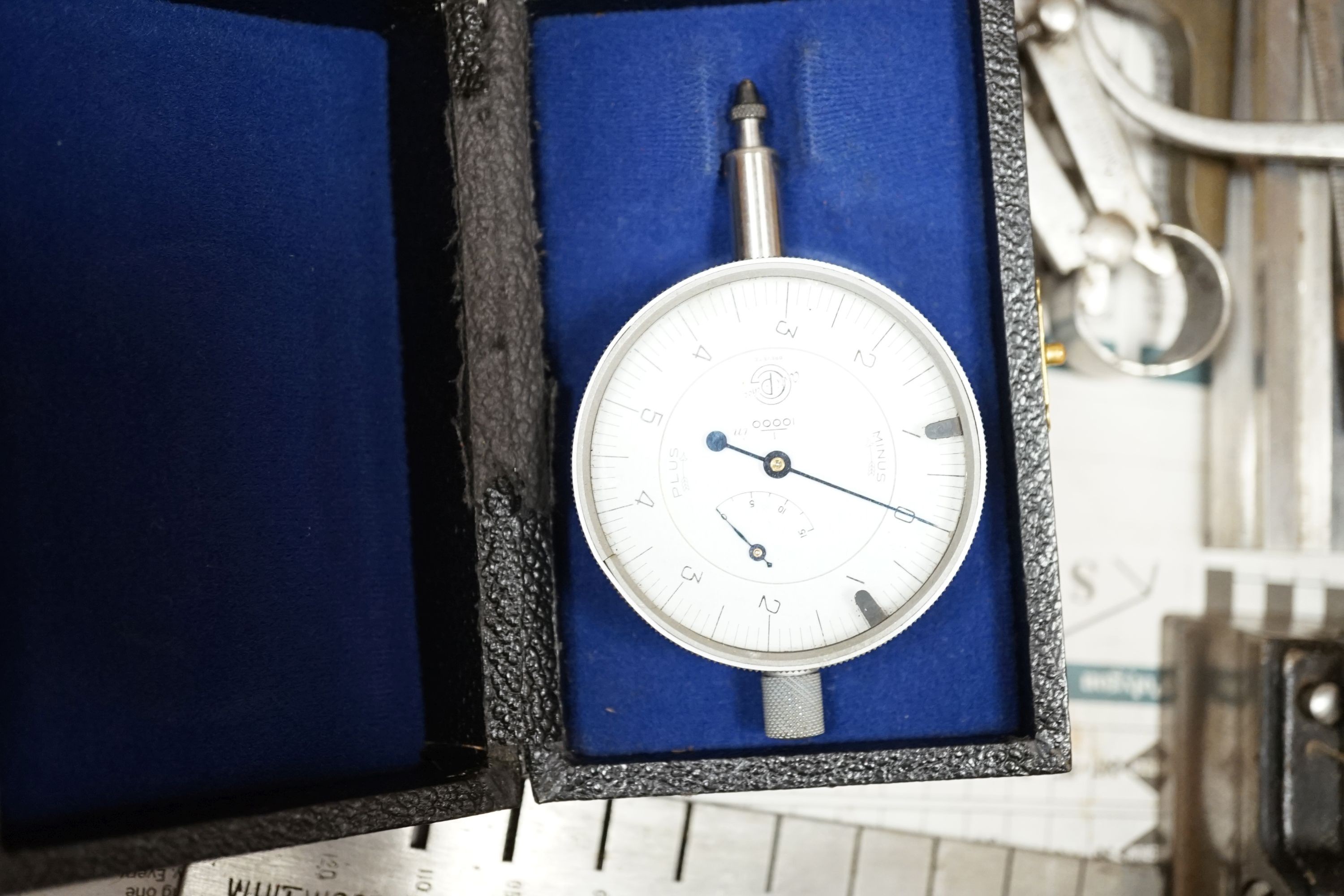A collection of 20th century high precision metal measuring devices, including callipers, Compac dial micrometers, feeler gauges, wire gauges, a set square, steel cutting wheels etc
